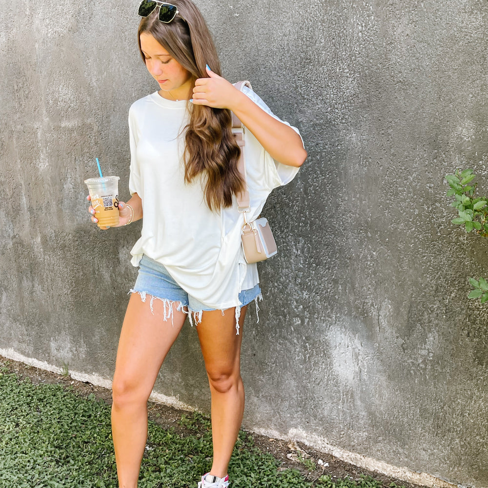 
                      
                        Oversized V-neck White Tee
                      
                    